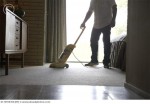 Man Vacuuming Bedroom