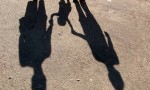 shadow of young family holding hands
